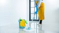 Young housekeeper or washing cleaning floor at mop in protective gloves, Housework Cleaning service