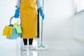 Young housekeeper or washing cleaning floor at mop in protective gloves, Housework Cleaning service