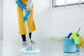 Young housekeeper or washing cleaning floor at mop in protective gloves, Housework Cleaning service
