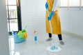 Young housekeeper or washing cleaning floor at mop in protective gloves, Housework Cleaning service