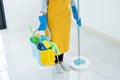 Young housekeeper or washing cleaning floor at mop in protective gloves, Housework Cleaning service