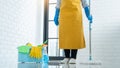 Young housekeeper or washing cleaning floor at mop in protective gloves, Housework Cleaning service