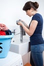 Young housekeeper washing the clothes
