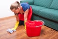 Young housekeeping lady wiping the wooden floor Royalty Free Stock Photo