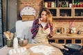 Housewife against table with flour, eggs and milk