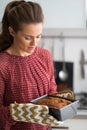 Young housewife with baking dish with bread Royalty Free Stock Photo