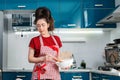 Young housewife cooks in the kitchen. Concept of making homemade slow food