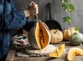 young housewife cutting pumpkin