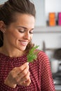 Young housewife holding fresh dill