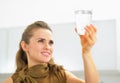 Young housewife looking on glass of water