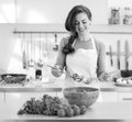 Young housewife mixing fresh salad Royalty Free Stock Photo