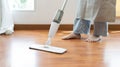 Young housewife mopping and cleaning the wooden floor Royalty Free Stock Photo