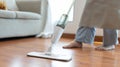 Young housewife mopping and cleaning the wooden floor Royalty Free Stock Photo