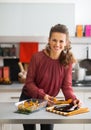 Young housewife serving baked pumpkin