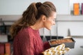 Young housewife smelling baking dish with bread Royalty Free Stock Photo