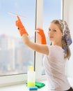 Young housewife washing the window Royalty Free Stock Photo