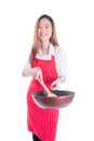 Young housewife wearing red apron and holding pan