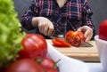 A woman making a fresh vegetable salad