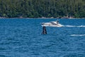 A young Humpback Whale breaching with onloookers in Auke Bay on the outskirts of Juneau, Alaska