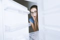 Desperate woman looking into her empty fridge Royalty Free Stock Photo