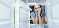 Desperate woman looking into her empty fridge Royalty Free Stock Photo