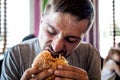 A young man eating a burger