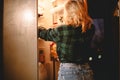 Young woman looking for food in fridge at night at home Royalty Free Stock Photo