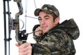 Young hunter with bow aiming Royalty Free Stock Photo