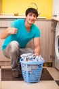 The young husband man doing laundry at home Royalty Free Stock Photo