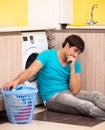 Young husband man doing laundry at home Royalty Free Stock Photo