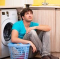 Young husband man doing laundry at home Royalty Free Stock Photo