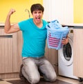 Young husband man doing laundry at home Royalty Free Stock Photo