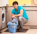 Young husband man doing laundry at home Royalty Free Stock Photo