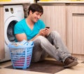 Young husband man doing laundry at home Royalty Free Stock Photo