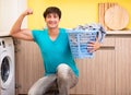 Young husband man doing laundry at home Royalty Free Stock Photo