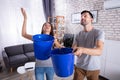 Husband And Wife With Blue Bucket Collecting Water Royalty Free Stock Photo