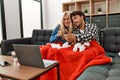 Young ill couple having medical teleconsultation using laptop at home Royalty Free Stock Photo