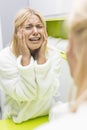 Young ill woman crying while looking at mirrior in bathroom Royalty Free Stock Photo