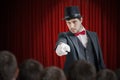 Young illusionist or magician is selecting volunteer from the audience