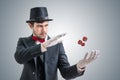 Young illusionist or magician is showing magic trick with levitating dice