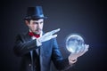 Young illusionist is predicting future and fortune telling from magical ball Royalty Free Stock Photo