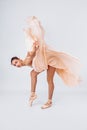 A young and incredibly beautiful ballerina is posing and dancing in a white studio full of light. The beauty of classical ballet Royalty Free Stock Photo