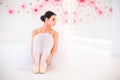 Young and incredibly beautiful ballerina is posing and dancing in a white studio full of light.