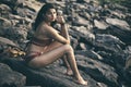 Young India girl in red bikini enjoying her vacation on beach and relaxing on beach