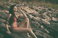 Young India girl in red bikini enjoying her vacation on beach and relaxing on beach