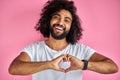 Young indian or arabic man smiling in love doing heart symbol shape with hands Royalty Free Stock Photo