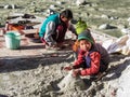 A young Indian boy building a sand castle