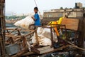 Young Indian boy making faces on the pile of trash in Mumbai, India Royalty Free Stock Photo