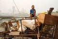 Young Indian boy making faces on the pile of trash in Mumbai, India Royalty Free Stock Photo