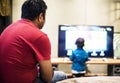 Young Indian boy watching television